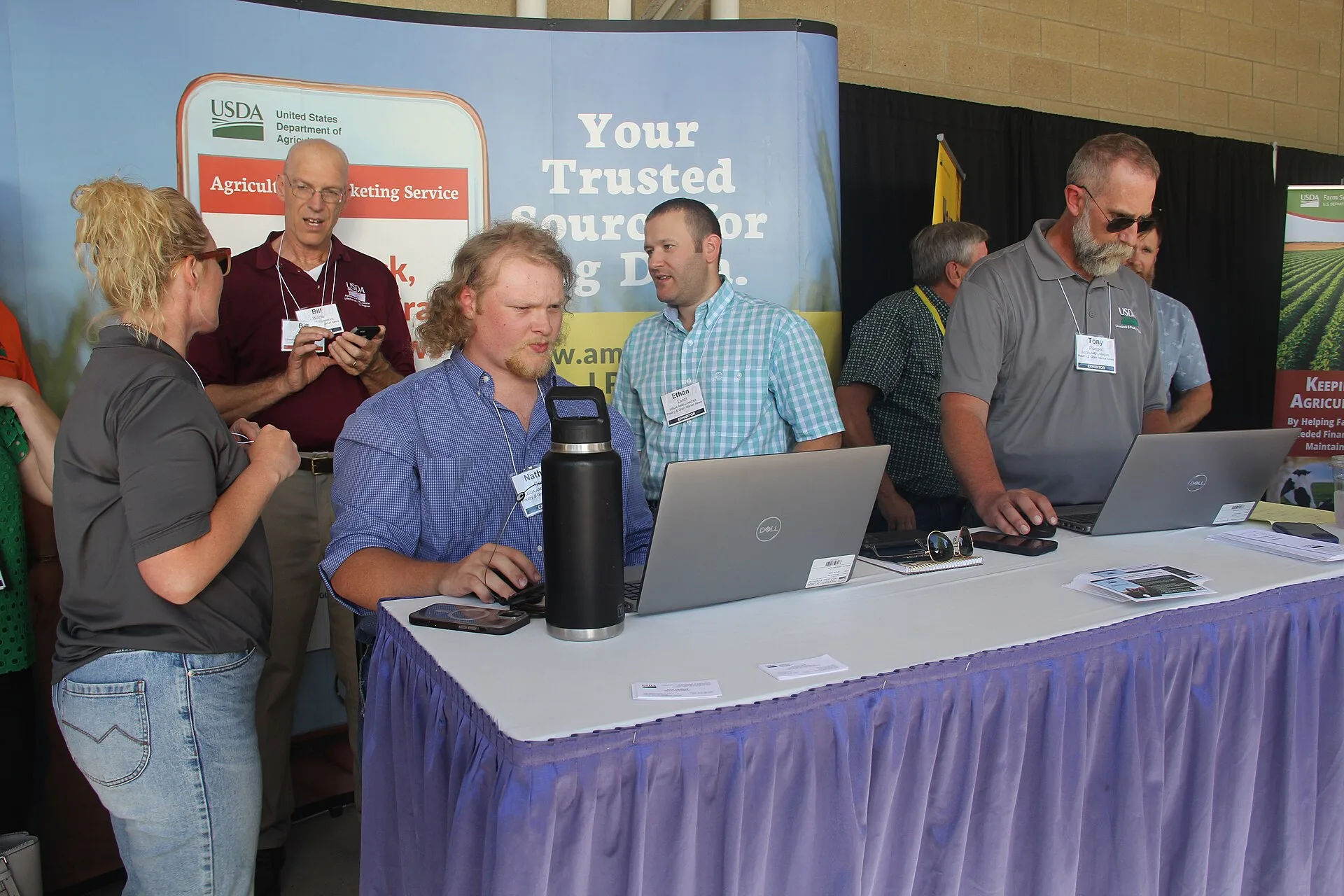 U.S. Department of Agriculture (USDA) Agricultural Marketing Service staff at the World Pork Expo. Nathan Coale and Tony Ploeger prepare the swine market report while (from left to right) Alexis Meyers, Bill Worlie, and Ethan Lantz provide support. U.S. Department of Agriculture (USDA) Under Secreta